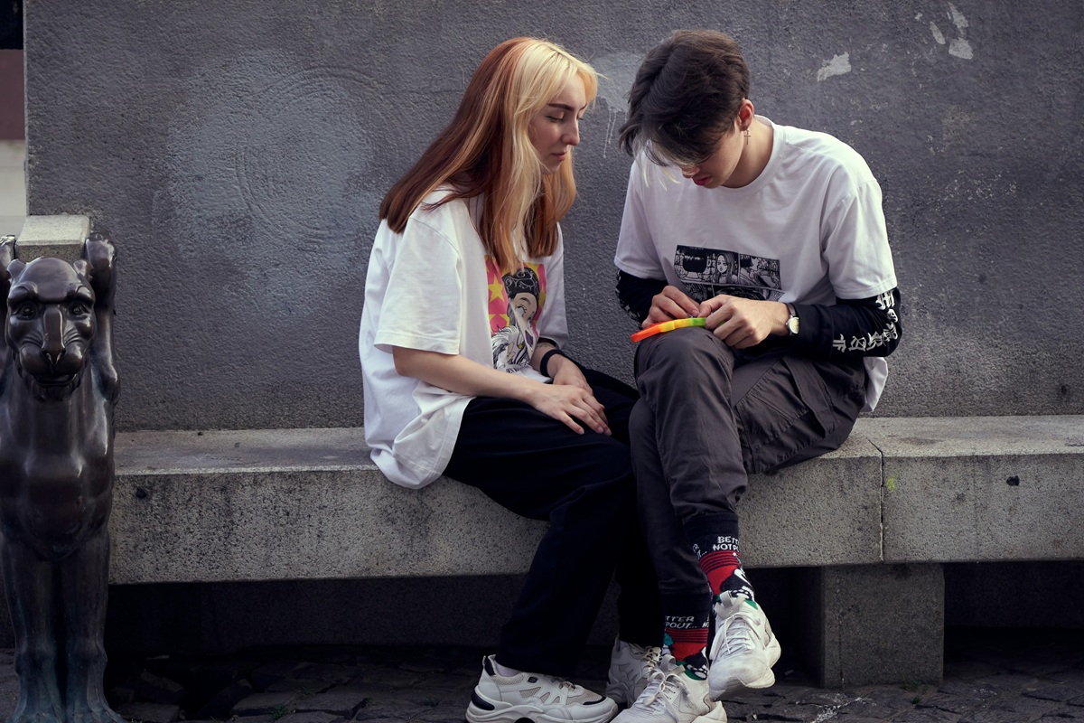 Two young people sitting together outdoors